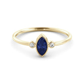 A delicate marquise sapphire ring and a pair of diamonds