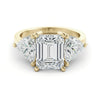 A gold ring with a large, clear gemstone in the center, surrounded by smaller diamonds on either side.