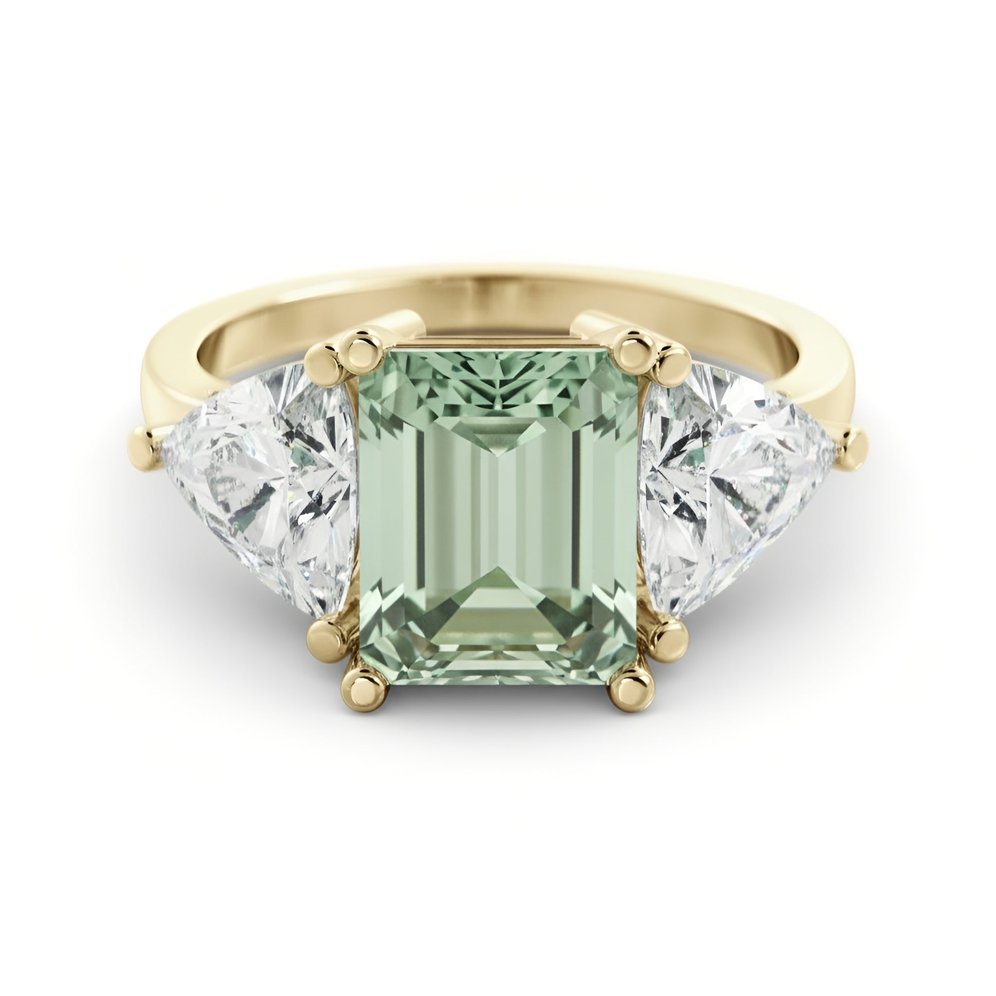 A gold ring with a large, green gemstone in the center, flanked by two smaller diamonds on either side.