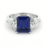 A silver ring with a large blue gemstone in the center, surrounded by smaller diamonds.