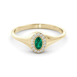 A delicate signet ring set with emeralds and diamonds
