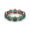 An emerald eternity ring studded with diamonds