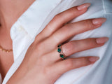 An emerald eternity ring studded with diamonds