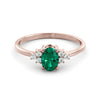 A delicate emerald and diamond ring