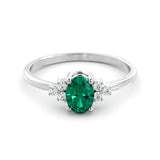 A delicate emerald and diamond ring