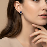 A pair of Halo sapphire and diamond earrings
