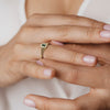 A delicate signet ring set with emeralds and diamonds